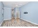 Well-lit bedroom featuring wood-look flooring, ceiling fan, and attached bathroom at 11305 Hunters Landing Dr, Charlotte, NC 28273