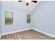 Bedroom featuring modern vinyl floors, fresh blue paint and two windows at 11305 Hunters Landing Dr, Charlotte, NC 28273
