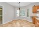 Bright breakfast nook with a bay window, chandelier, and tile flooring next to the kitchen at 11305 Hunters Landing Dr, Charlotte, NC 28273