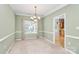 Dining room with a chandelier, carpet, chair rail, and natural light at 11305 Hunters Landing Dr, Charlotte, NC 28273