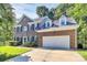 Charming two-story brick home featuring a two-car garage, dormer windows, and well-manicured landscaping at 11305 Hunters Landing Dr, Charlotte, NC 28273