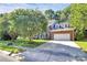 Traditional brick home with manicured lawn, mature trees, and a two-car garage at 11305 Hunters Landing Dr, Charlotte, NC 28273