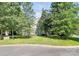 Charming home with lush front lawn and mature trees in a desirable neighborhood at 11305 Hunters Landing Dr, Charlotte, NC 28273