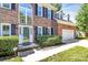 Close-up shot of the home's entryway shows a beautiful glass front door and manicured landscaping at 11305 Hunters Landing Dr, Charlotte, NC 28273