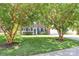 Traditional brick home with well-manicured lawn and mature trees enhancing curb appeal at 11305 Hunters Landing Dr, Charlotte, NC 28273