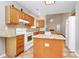 Well-lit kitchen with wood cabinets, granite countertops, and a center island at 11305 Hunters Landing Dr, Charlotte, NC 28273