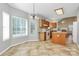 Bright kitchen featuring tile flooring, white appliances, and an adjacent breakfast area at 11305 Hunters Landing Dr, Charlotte, NC 28273