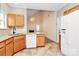 Functional kitchen with light wood cabinets, white appliances, and tile flooring at 11305 Hunters Landing Dr, Charlotte, NC 28273