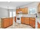 Bright kitchen featuring light wood cabinets, tile backsplash, and plenty of countertop space at 11305 Hunters Landing Dr, Charlotte, NC 28273