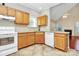 Functional kitchen with light wood cabinets, white appliances, and tile flooring at 11305 Hunters Landing Dr, Charlotte, NC 28273