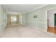 Spacious living room featuring carpet, chair railing, natural light, and open access to other spaces at 11305 Hunters Landing Dr, Charlotte, NC 28273
