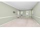 Large living room featuring carpet, chair railing, and natural light at 11305 Hunters Landing Dr, Charlotte, NC 28273