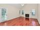 Living room with fireplace, hardwood flooring, vaulted ceiling, and exterior access at 11305 Hunters Landing Dr, Charlotte, NC 28273