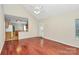 Open-concept living room with hardwood floors, access to kitchen, and natural light at 11305 Hunters Landing Dr, Charlotte, NC 28273