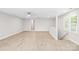Finished basement space with luxury vinyl plank flooring and a window at 1134 Willow Oaks Trl, Matthews, NC 28104