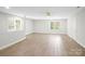 Spacious finished basement featuring luxury vinyl plank flooring, neutral paint, and multiple windows at 1134 Willow Oaks Trl, Matthews, NC 28104