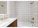 Modern bathroom features an ornate shower tile, updated showerhead and faucet, and a wood vanity at 1134 Willow Oaks Trl, Matthews, NC 28104