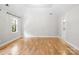 Bright bedroom with hardwood floors, tray ceiling, and large window filling the room with natural light at 1134 Willow Oaks Trl, Matthews, NC 28104