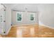 Spacious bedroom with hardwood floors, natural light, and large windows with views at 1134 Willow Oaks Trl, Matthews, NC 28104