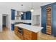 Beautiful kitchen with stainless appliances, a large island with white countertops, and stylish blue cabinets at 1134 Willow Oaks Trl, Matthews, NC 28104