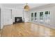 Spacious living area with hardwood floors, built-in shelves, fireplace, and backyard access at 1134 Willow Oaks Trl, Matthews, NC 28104