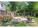 Backyard with lush grass and stone patio with deck is the perfect outdoor retreat at 11401 Lone Star Cir, Charlotte, NC 28226