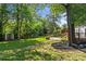 Spacious backyard with stone patio, shed, and mature trees offers a private outdoor space at 11401 Lone Star Cir, Charlotte, NC 28226