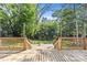 Wooden deck leads to stone patio and backyard with mature trees offering ample shade at 11401 Lone Star Cir, Charlotte, NC 28226