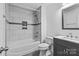 Updated bathroom with shower-tub combo, gray vanity, and gray ceramic tile flooring at 11401 Lone Star Cir, Charlotte, NC 28226