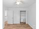 Bright bedroom features wood floors, a ceiling fan, and a closet with built-in shelving for optimal storage at 11401 Lone Star Cir, Charlotte, NC 28226