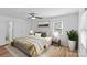 Comfortable bedroom featuring wood floors, neutral colored walls, a ceiling fan, and a large decorative plant at 11401 Lone Star Cir, Charlotte, NC 28226