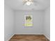 Bright, light-filled bedroom with ceiling fan, hardwood floors and a large window at 11401 Lone Star Cir, Charlotte, NC 28226