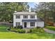 Charming two-story home with white siding, black shutters, and a well-manicured front yard at 11401 Lone Star Cir, Charlotte, NC 28226