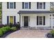 Welcoming front porch with brick pavers, lush landscaping, and a classic black front door at 11401 Lone Star Cir, Charlotte, NC 28226