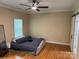 Bedroom featuring hardwood floors, ceiling fan and a modern sliding barn door to ensuite at 13221 Brandywine Ln, Midland, NC 28107
