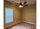 Bedroom featuring neutral walls, carpet, window, and a ceiling fan at 13221 Brandywine Ln, Midland, NC 28107