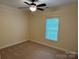 Bedroom featuring carpet, neutral walls, window, and a ceiling fan at 13221 Brandywine Ln, Midland, NC 28107