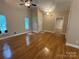 Bright living room boasts gleaming hardwood floors, vaulted ceilings, and lots of natural light from large windows at 13221 Brandywine Ln, Midland, NC 28107