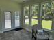 This light filled sunroom with tile floor boasts lots of windows and stylish furnishings at 13221 Brandywine Ln, Midland, NC 28107