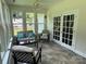 This light filled sunroom with tile floor boasts lots of windows and stylish furnishings at 13221 Brandywine Ln, Midland, NC 28107
