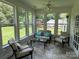 This light filled sunroom with tile floor boasts lots of windows and stylish furnishings at 13221 Brandywine Ln, Midland, NC 28107