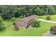 Aerial shot of brick home with a well manicured lawn and mature trees at 137 Proust Rd, Statesville, NC 28625