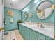 Bright bathroom featuring double sinks, decorative mirrors, and a neutral tile backsplash at 137 Proust Rd, Statesville, NC 28625