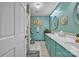 Bathroom featuring double sink vanity, custom lighting, and bright blue paint at 137 Proust Rd, Statesville, NC 28625