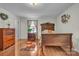 Bedroom featuring hardwood floors, natural light, and antique wooden furniture at 137 Proust Rd, Statesville, NC 28625