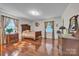 Bedroom with hardwood floors, two windows with curtains, and vintage-style furniture at 137 Proust Rd, Statesville, NC 28625