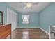 Bright bedroom with hardwood flooring, ceiling fan, and closet space at 137 Proust Rd, Statesville, NC 28625