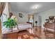 Bright bedroom with hardwood floors, vintage furniture, and large windows with decorative curtains at 137 Proust Rd, Statesville, NC 28625