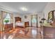 Bedroom with hardwood floors, two windows with curtains, and vintage-style furniture at 137 Proust Rd, Statesville, NC 28625