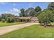 Charming brick home with manicured lawn and mature trees at 137 Proust Rd, Statesville, NC 28625